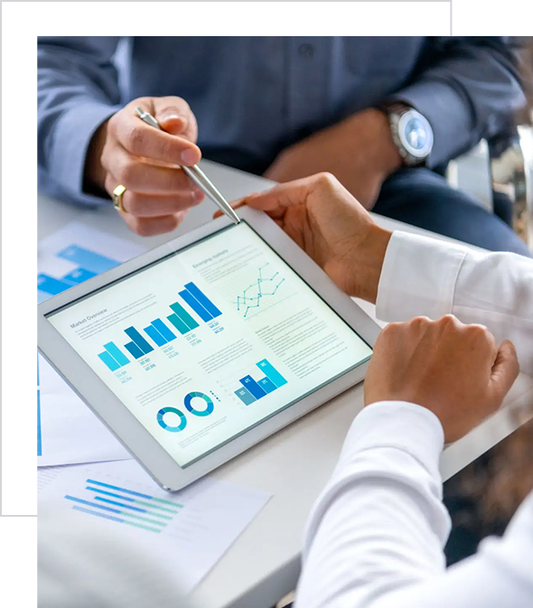 Two professionals analyzing financial data on a tablet during a meeting.