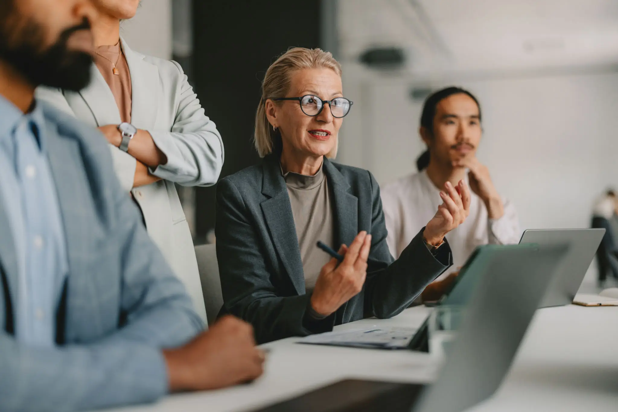 Professional woman explaining a point in a meeting.