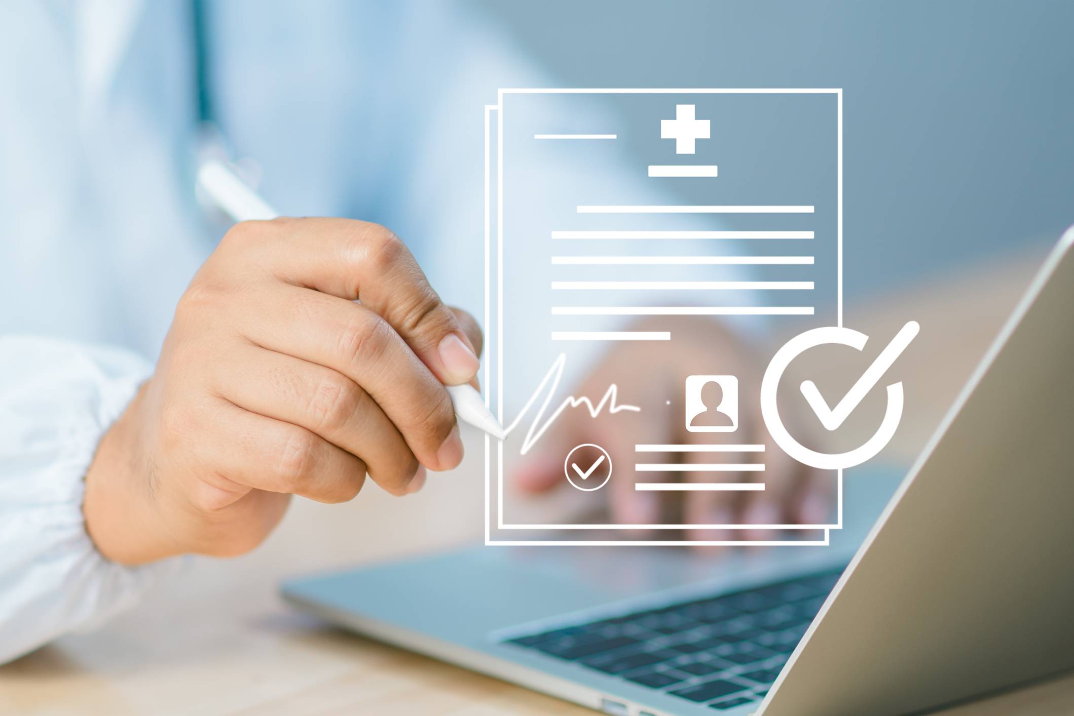 A doctor signing a digital medical document on a laptop.