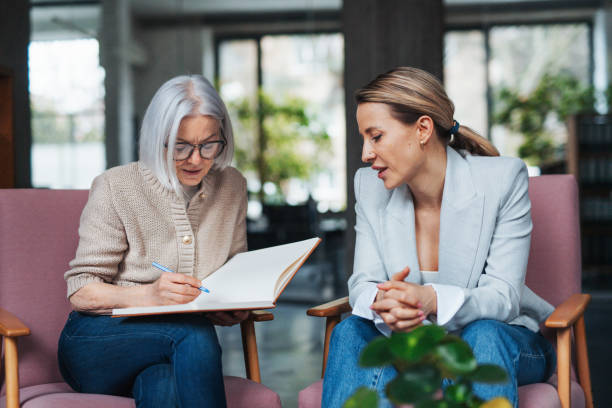 Workplace mental health coaching for female manager. Mental health coach helping to navigate stress, anxiety and manage work life balance for female worker. Organisational or business psychologist offering counselling in company.