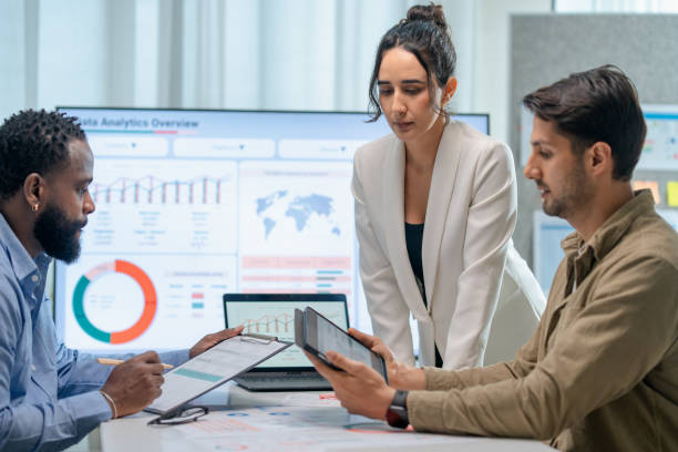 Increase credibility and Trust in communication to build Powerful Relationships. Business teamwork presented to their customer in a board room. They are discussing a business project over info-graphic data on a screen in a business office.